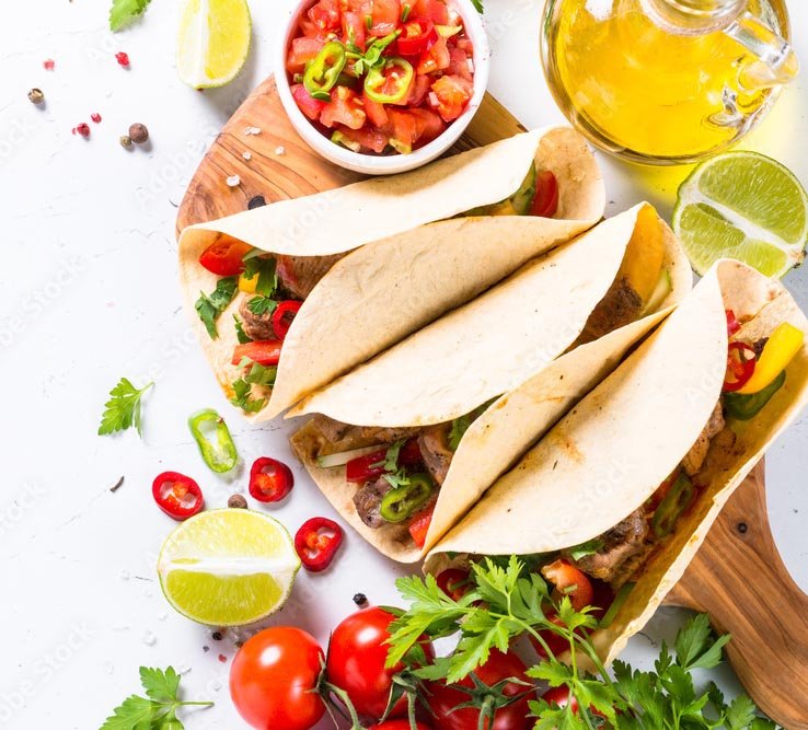 Catering staff serving fresh tacos on site at a Toronto event